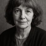 A black-and-white portrait of a thoughtful middle-aged woman with wavy hair, evoking a contemplative mood.